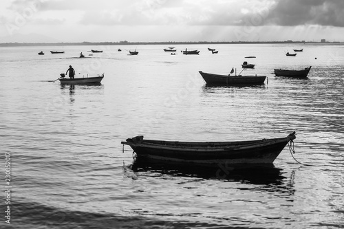 Black and white photo, fishermen are fishing out in the morning.
