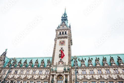 Hamburg City Hall building located in the Altstadt quarter in the city center at the Rathausmarkt square in a cold rainy early spring day photo