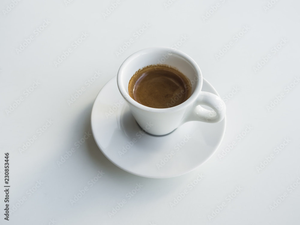White cup with black coffee on white table. White cup with black coffee on white table.