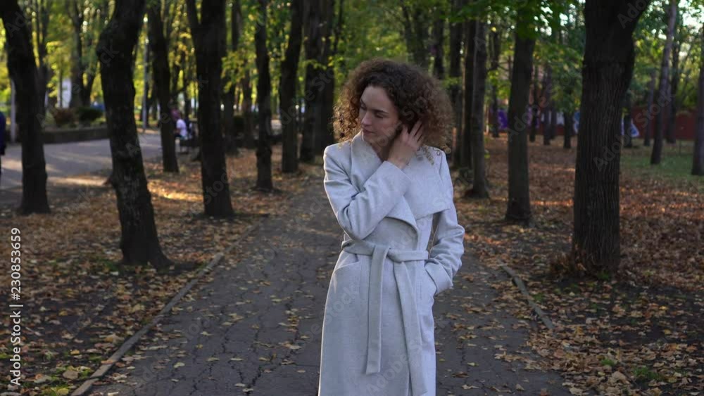 Young woman in autumn park. Autumn, curly girl in the park. Young woman in autumn park. Autumn, curly girl in the park.