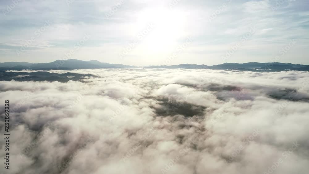 Aerial view drone shot of flowing fog waves on mountain tropical rainforest in phang nga thailand Aerial view drone shot of flowing fog waves on mountain tropical rainforest in phang nga thailand