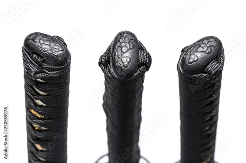 3 views of pine Kashira : butt cap (or pommel) made of steel on the end of the black cord handle  Japanese sword isolated in white background. photo