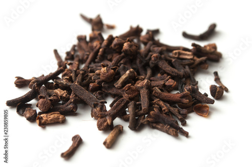 closeup of cloves pile on white background
