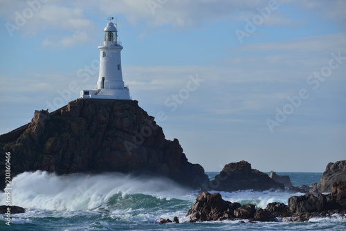 La Corbiere lighthouse, Jersey, U.K. Telephoto image of a coastal structure.