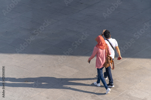 Aerial photo of people walk on the walkway in front of the mall in the city
