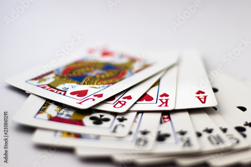 Queen, King, Jack, Ace from each Suit fanned out across back of cards, 