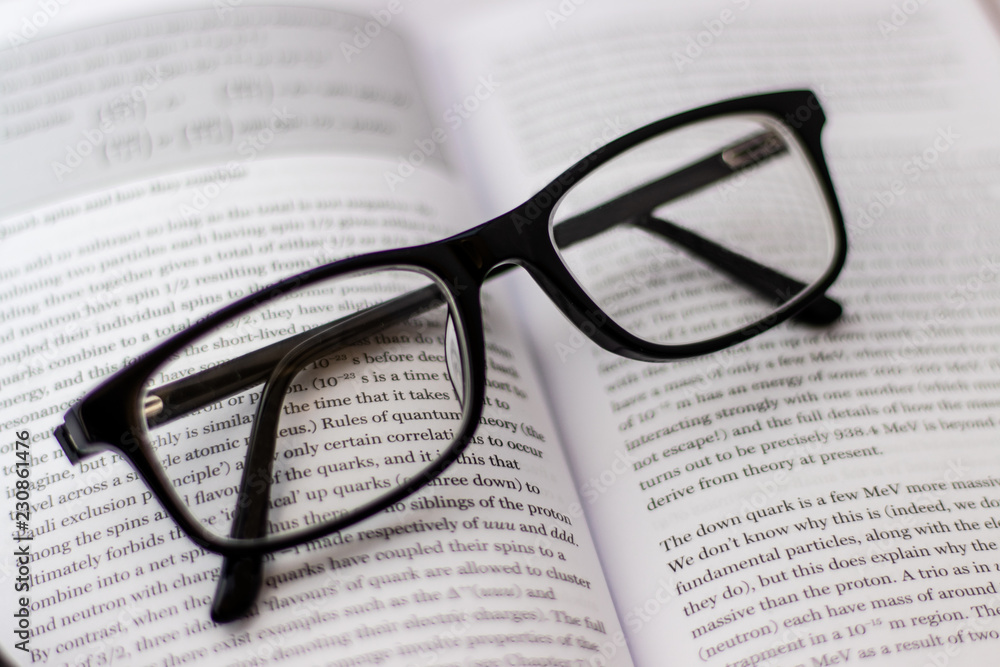 Pair of black glasses lying around on white background Pair of black glasses lying around on white background