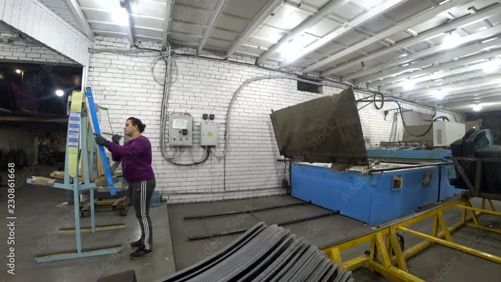 Worker checks the quality of the glass. Production of auto glass. Worker checks the quality of the glass. Production of auto glass.