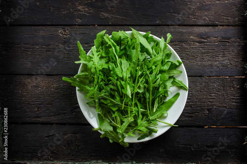 Arugula - fresh salad (rucola) on a gray background. top view. copy space