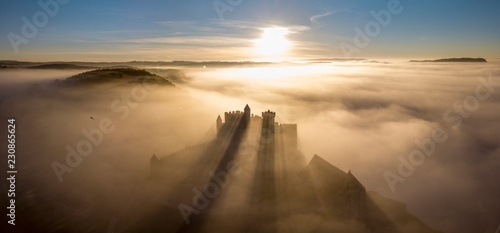 Chateau Beynac in fog in the early morning Perigord Noir Dordogne France