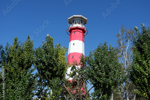 Lighthouse in the middle of green trees