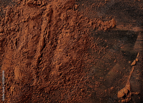 pile cocoa powder pile on black background, top view