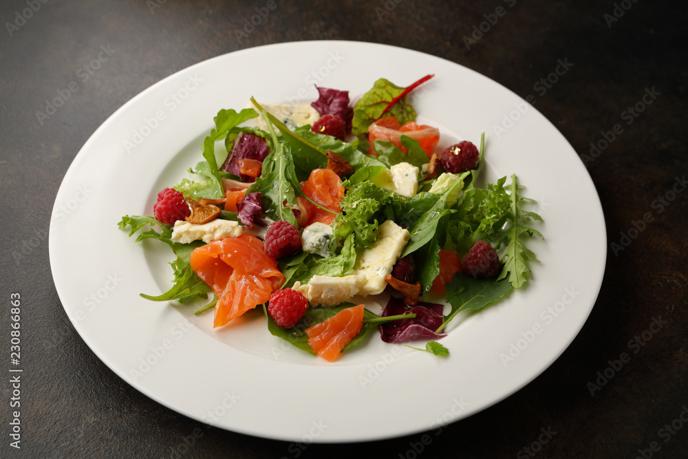 Fresh salad with salmon and cheese on plate Fresh salad with salmon and cheese on plate