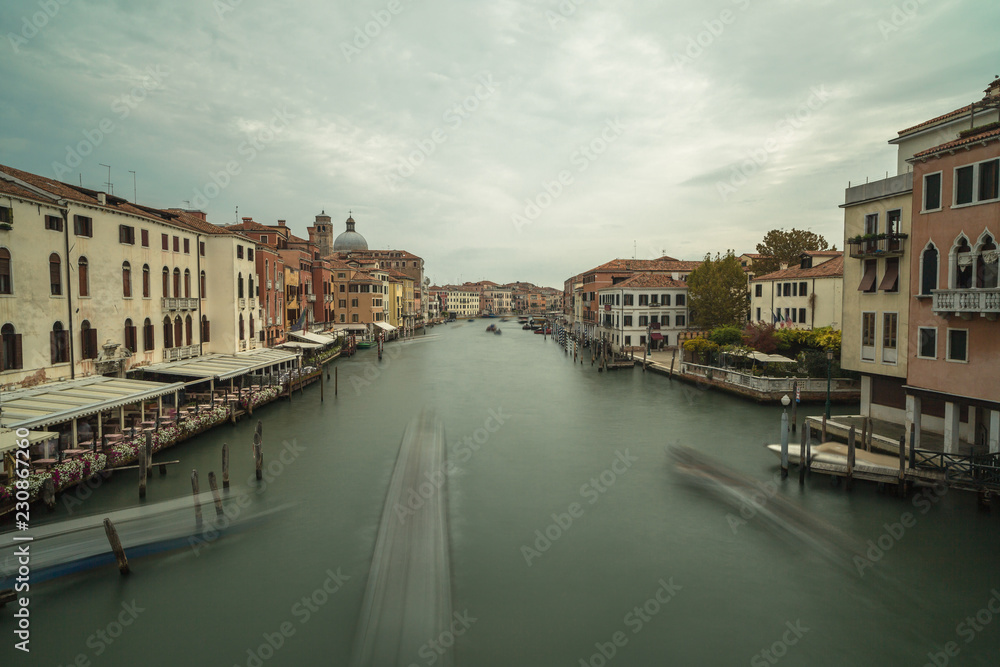 View on Grand Canal with passing by boat in Venice,long exposure photo.