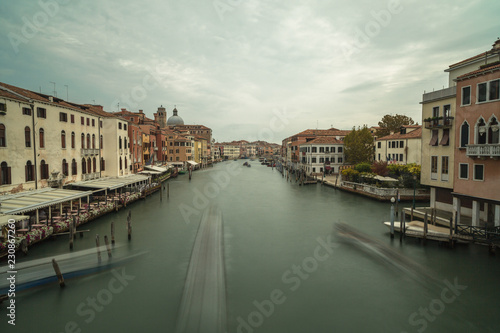 View on Grand Canal with passing by boat in Venice long exposure photo.