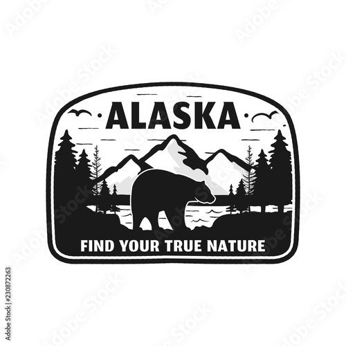 Alaska badge design. Mountain adventure patch. American travel logo. Cute retro style. Find your true nature custom quote. Bear walking through the forest. Stock vector silhouette emblem