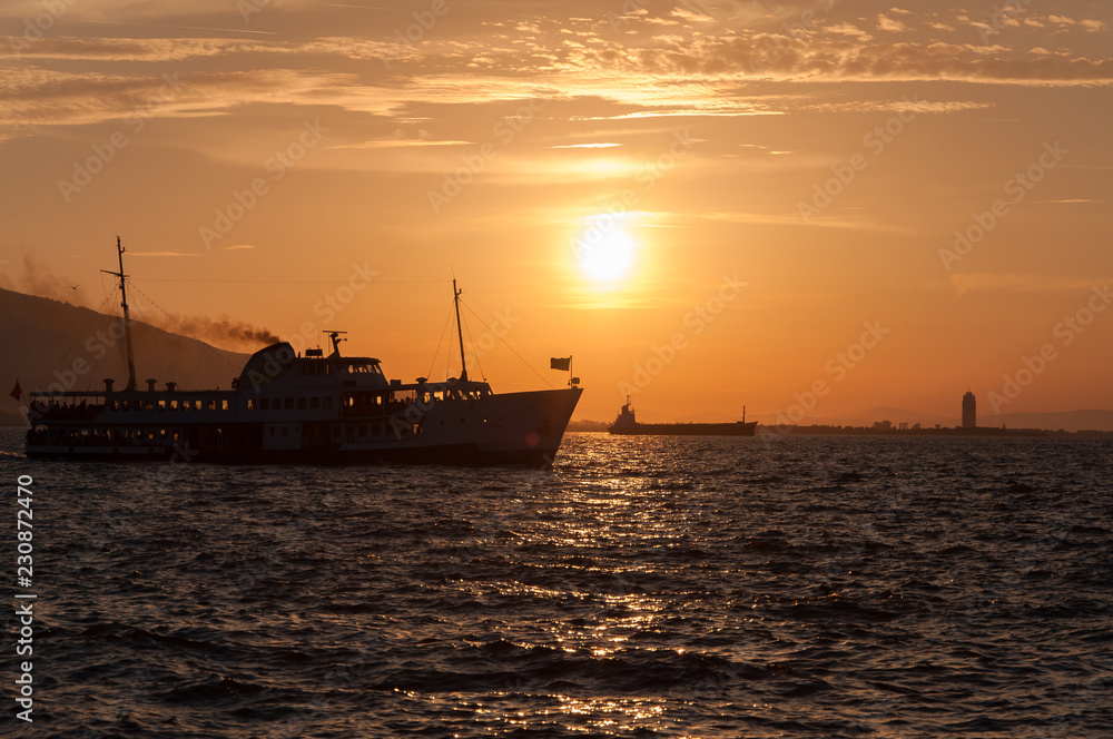 Ship at sea on a background of sunset sky