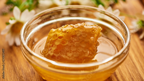 Honeycomb in glass bowl. Close-up of honey. Healthy organic. Sweet dessert background