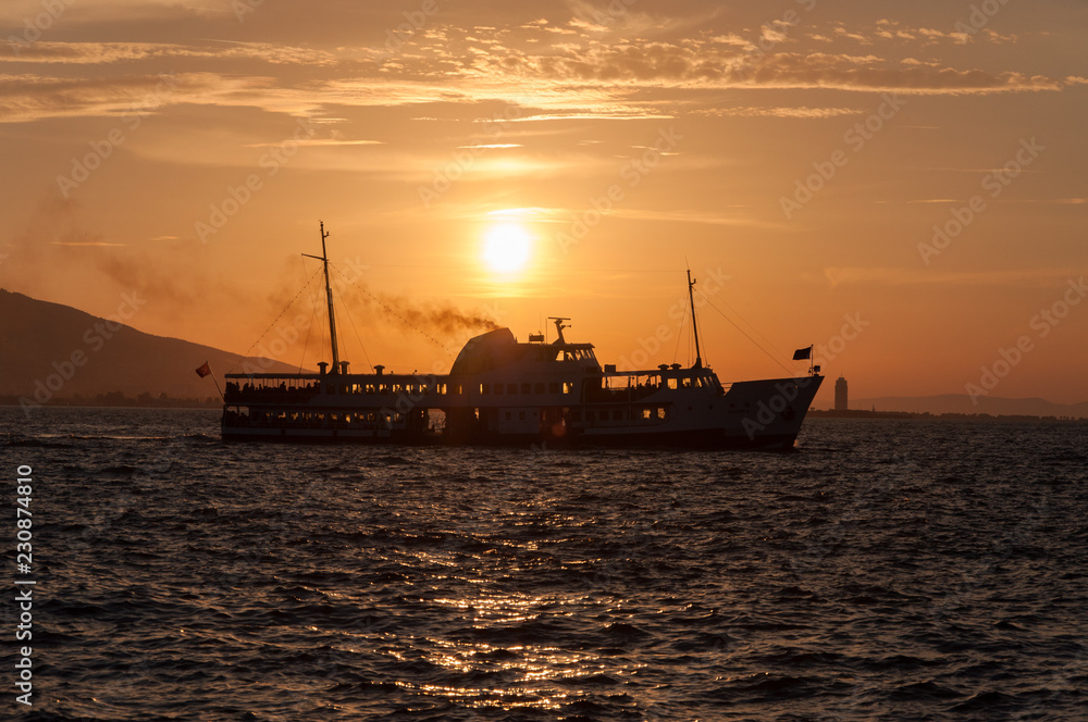 Ship at sea on a background of sunset sky.