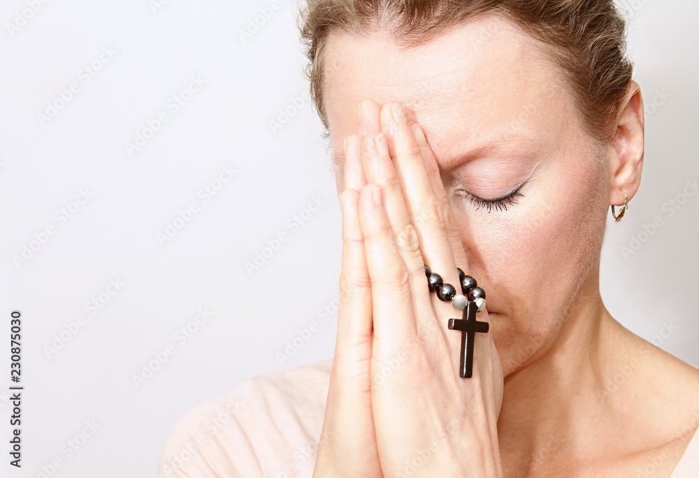 woman holding cross in her hands woman holding cross in her hands