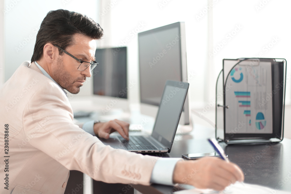 businessman writing down information in a notebook businessman writing down information in a notebook