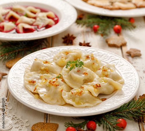 Dumplings with mushroom cabbage filling on a white plate. Vegetarian food, Traditional Christmas eve dish in Poland