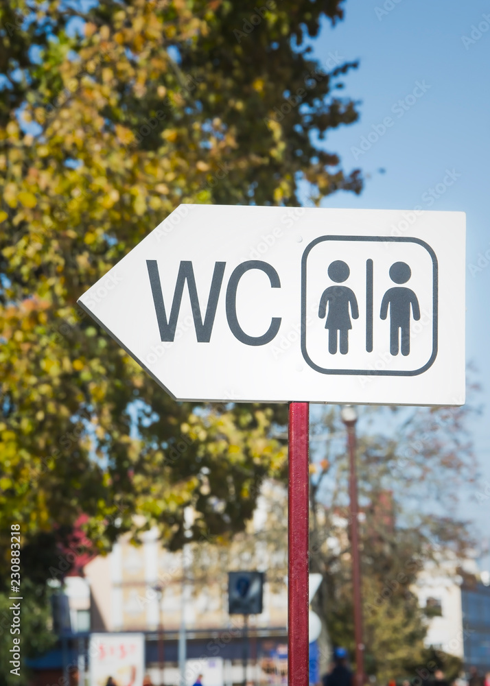 modern public toilet sign on the street in the city