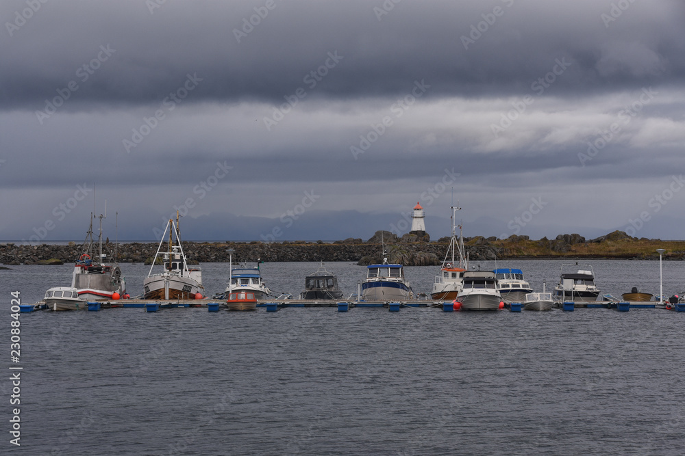 Fototapeta premium Boats and the lighthouse in Hovsund, Lofoten, Norway