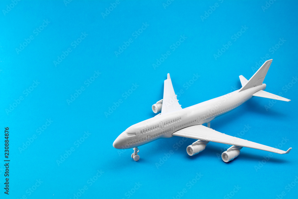 white airplane on a blue background. minimal trip and travel creative concept white airplane on a blue background. minimal trip and travel creative concept