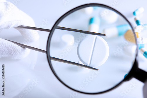 suspicious medications under a magnifying glass