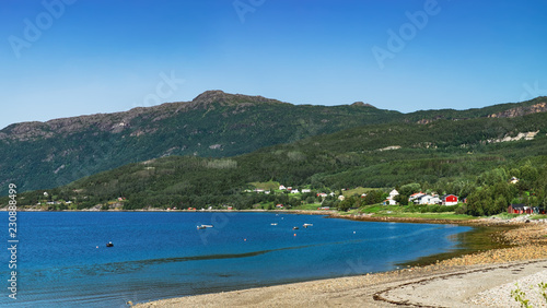 Panoramic view from Langstranda, the coast of Rombaken by the E6 road in Narvik municipality, Norway. Norwegian sea bay in summer scenery