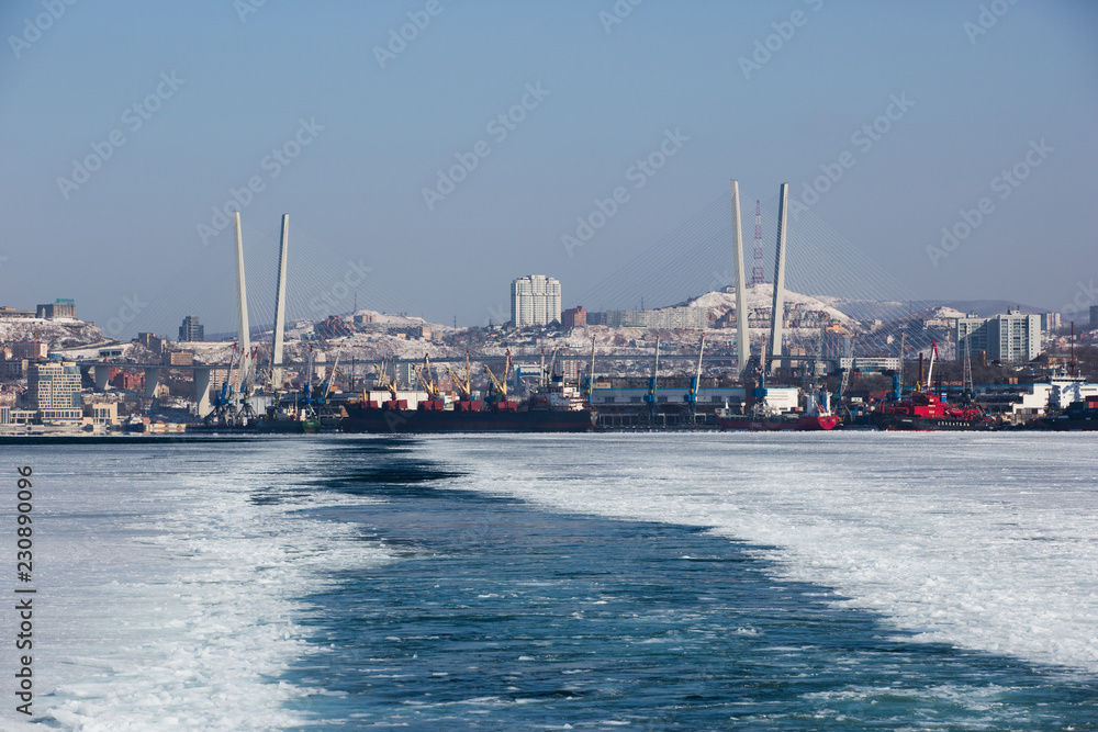 Ship in the frozen water area of the Golden Horn Bay in Vladivostok