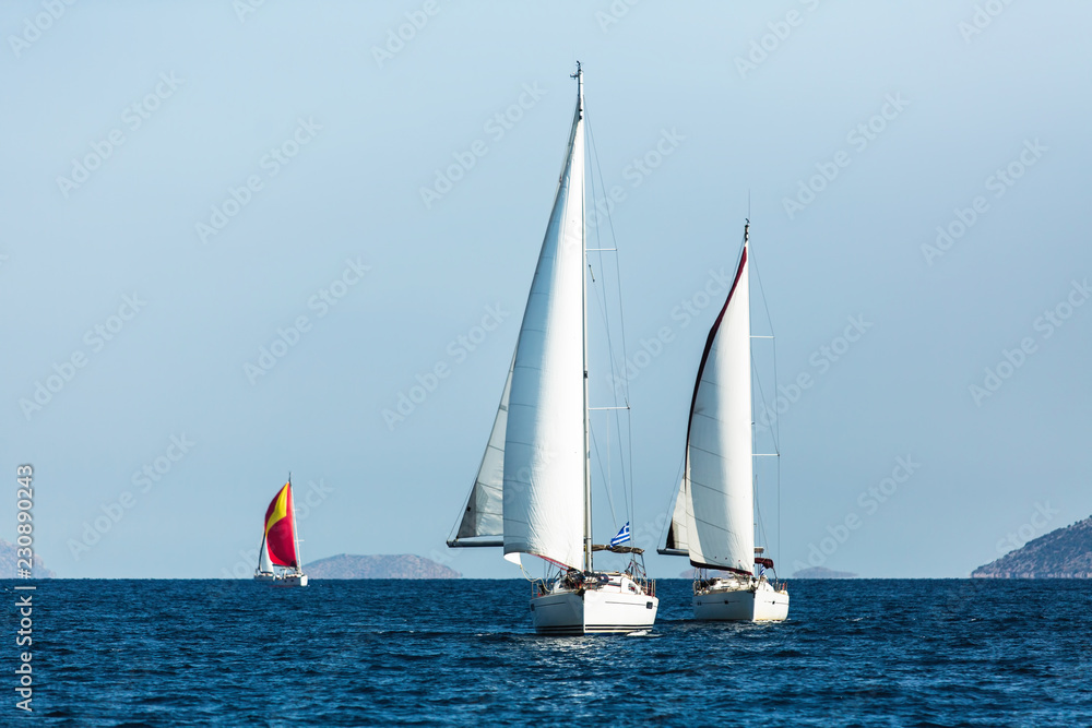 Sailing luxury boats during yacht regatta in the Aegean Sea at Greece.