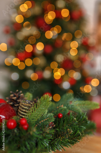 Abstract christmas background with christmas tree with decorations  defocused bokeh lights.