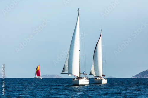 Sailing luxury boats during yacht regatta in the Aegean Sea at Greece.