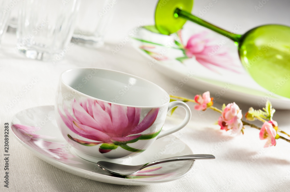 Table set up with dinnerware, napkin, silverware, jar and cups of glass on table cloth Table set up with dinnerware, napkin, silverware, jar and cups of glass on table cloth
