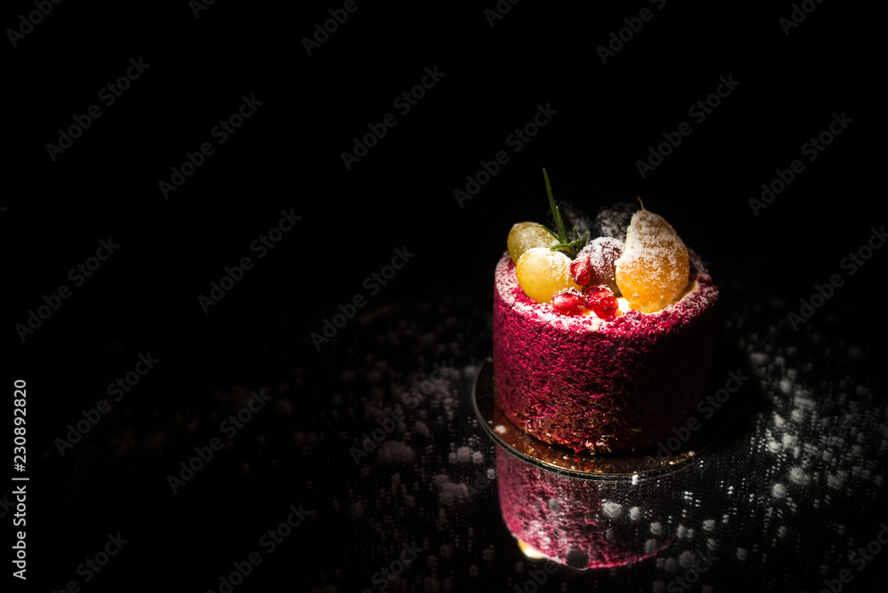 Tasty red cake with fruit on a black background Stock Photo | Adobe Stock