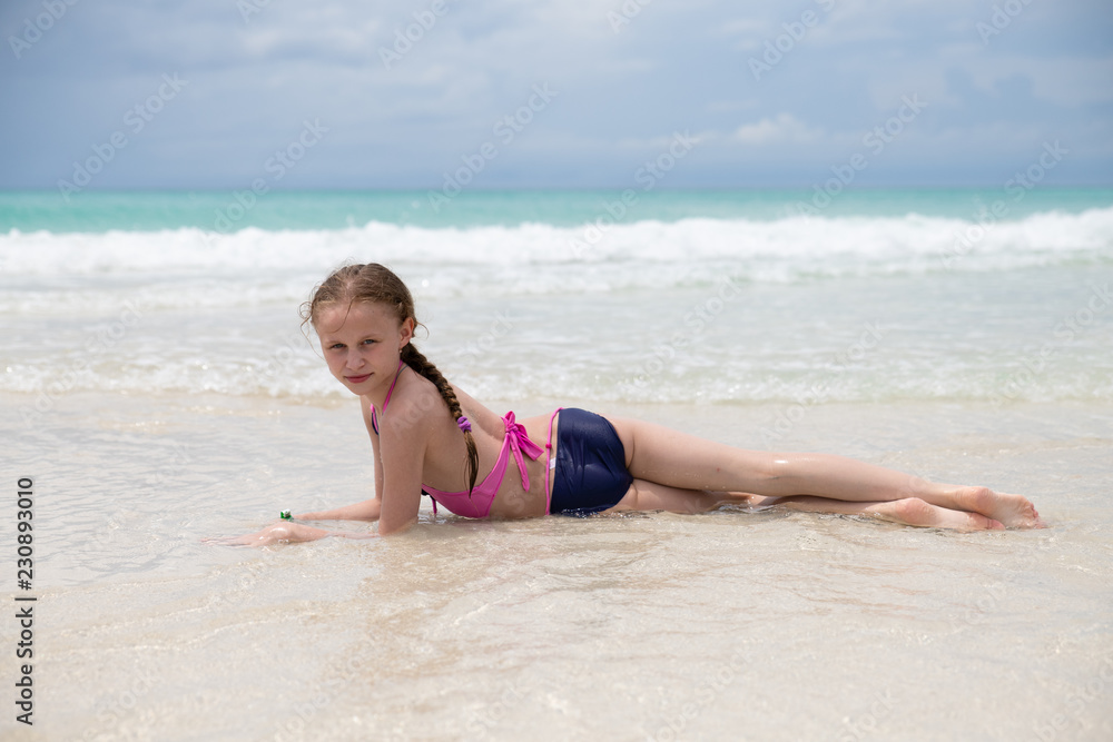 children playing on the beach by the ocean children playing on the beach by the ocean