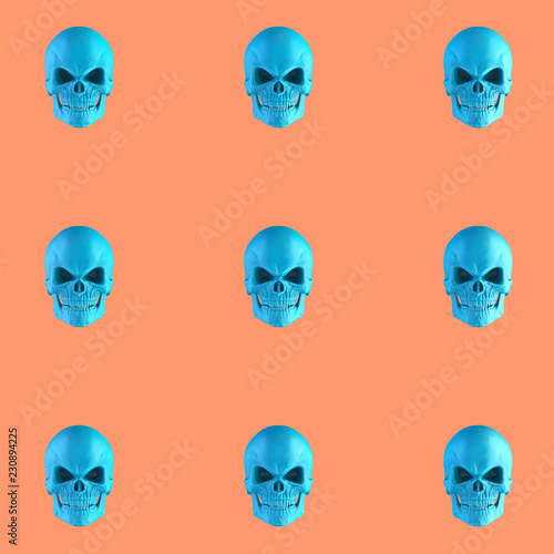 Pattern of blue skulls on orange background