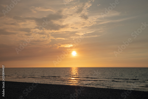 sandy beach by the ocean at sunset