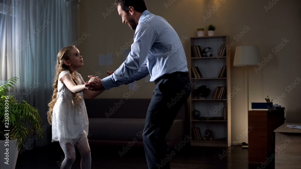 Father moving to music at home, inviting daughter to dance, having fun together Father moving to music at home, inviting daughter to dance, having fun together