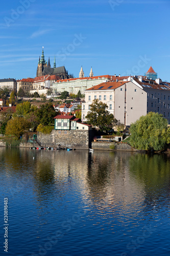 Colorful autumn Prague gothic Castle with the Lesser Town above River Vltava in the sunny Day, Czech Republic