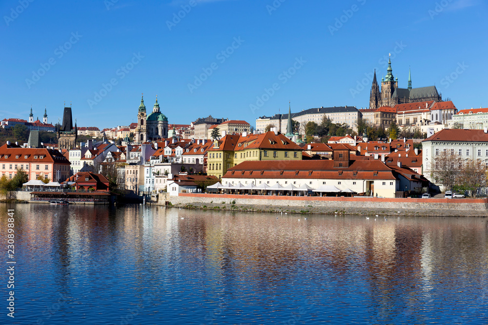 Colorful autumn Prague gothic Castle with the Lesser Town above River Vltava in the sunny Day, Czech Republic