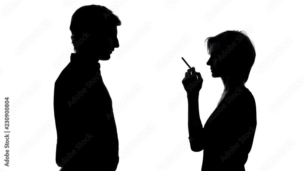 Silhouette of man looking at female smoking, bad habit harmful for health Silhouette of man looking at female smoking, bad habit harmful for health
