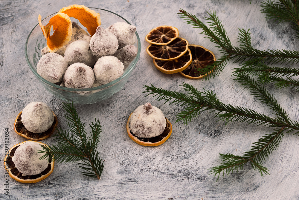 Chocolate candies-dessert for decoration of a festive table, slices of the dried lemon, a branch of a fir-tree with green needles. Chocolate candies-dessert for decoration of a festive table, slices of the dried lemon, a branch of a fir-tree with green needles.