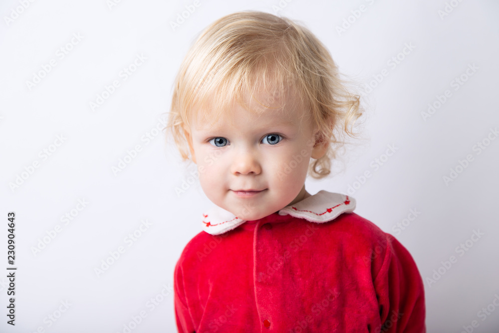 Portrait of cute cute baby girl 1.5 years old, in red clothes close-up on a white light background. concept christmas Portrait of cute cute baby girl 1.5 years old, in red clothes close-up on a white light background. concept christmas