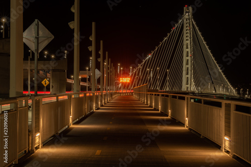 Walking and bike path under the east Bay Bridge tower at night