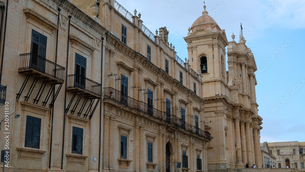 Noto, province of Syracuse, Sicily. View of the building at the left of St Nicholas Cathedral, that it can see in the background. Both buildings are representative of the sicilian baroque.