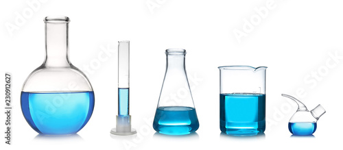 Set with different laboratory glassware and liquid for analysis on white background