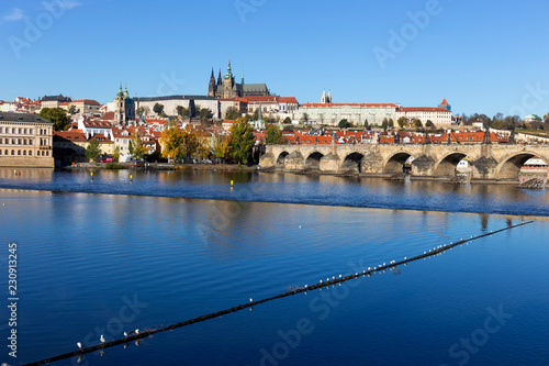 Colorful autumn Prague gothic Castle and Charles Bridge with the Lesser Town in the sunny Day, Czech Republic